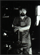David Little standing in front of an anvil.